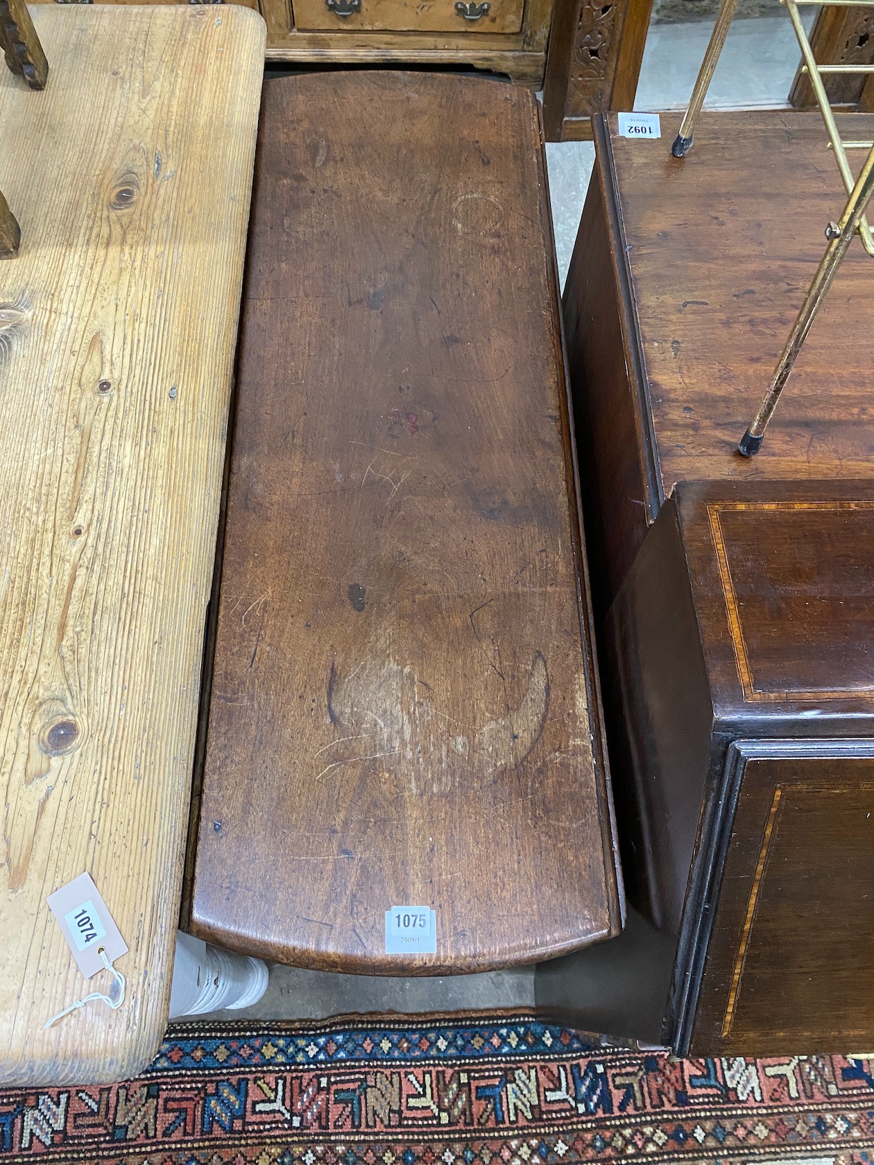 A George III mahogany drop leaf dining table with pad feet, width 106cm